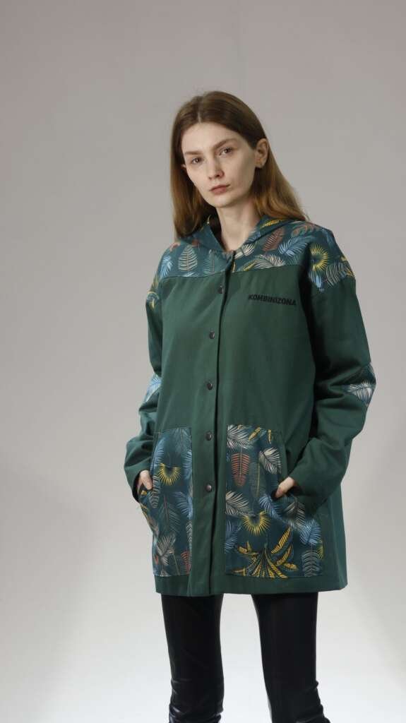 Fashion portrait of a woman wearing an emerald patterned jacket